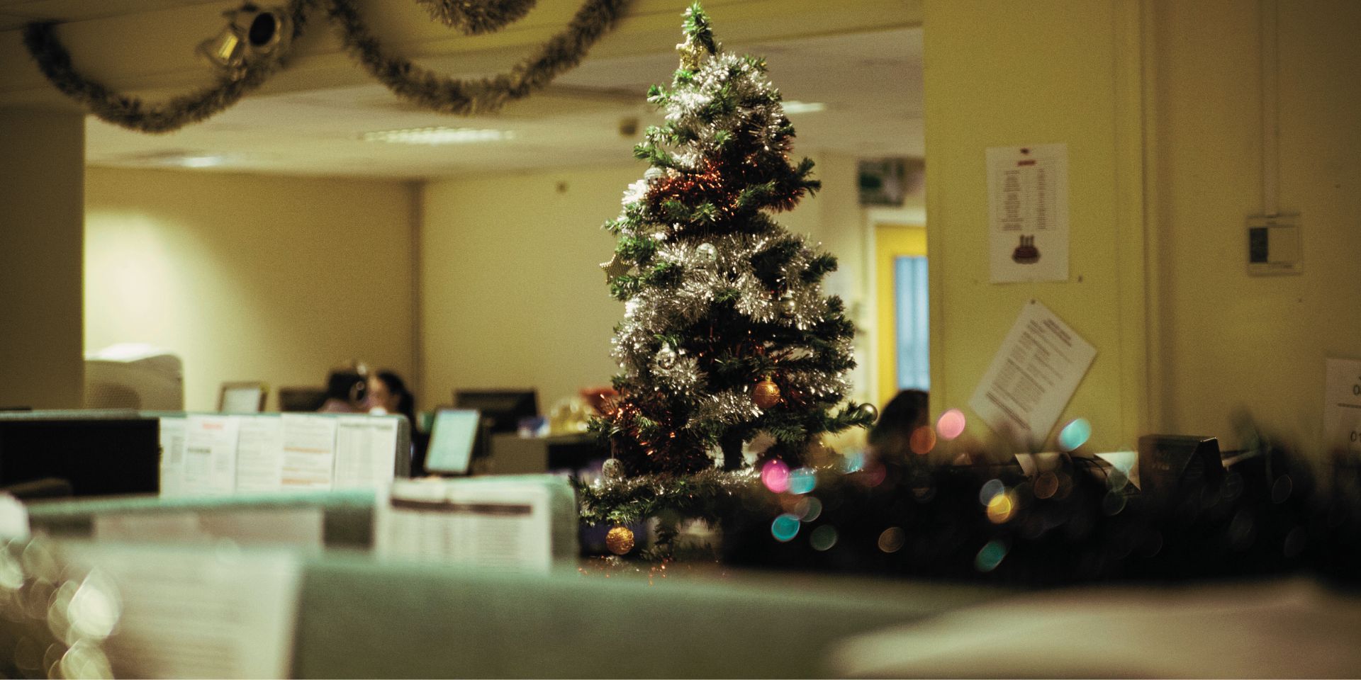 an empty office space during the christmas shutdown period with a christmas tree visible used on a blog about how to protect your business during the festive season